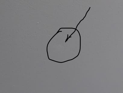 photo of a nail impression in the ceiling