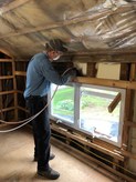 man installing spray foam insulation