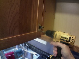 taking screws out of cabinet door